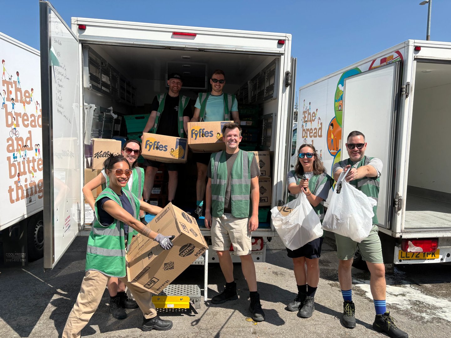 Volunteers unloading boxes of food from a delivery van