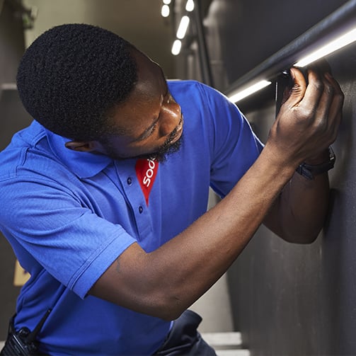 Sodexo employee fixing a light