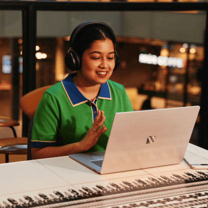feature_card_b_sitting_green_computer_hands_headphones_416x416px (1)