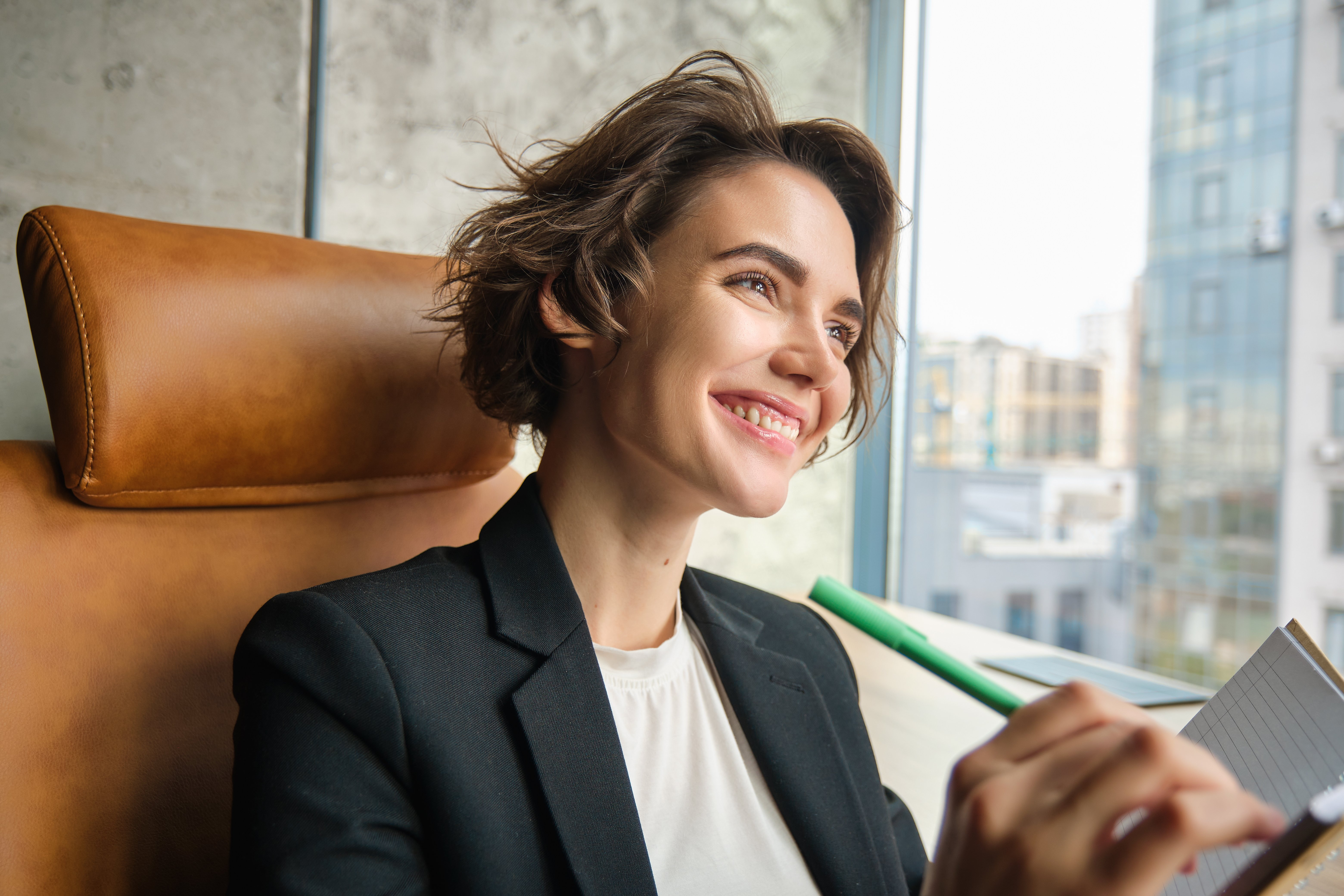 portrait-woman-working-her-office-businesswoman-sitting-with-her-notebook-writing-making