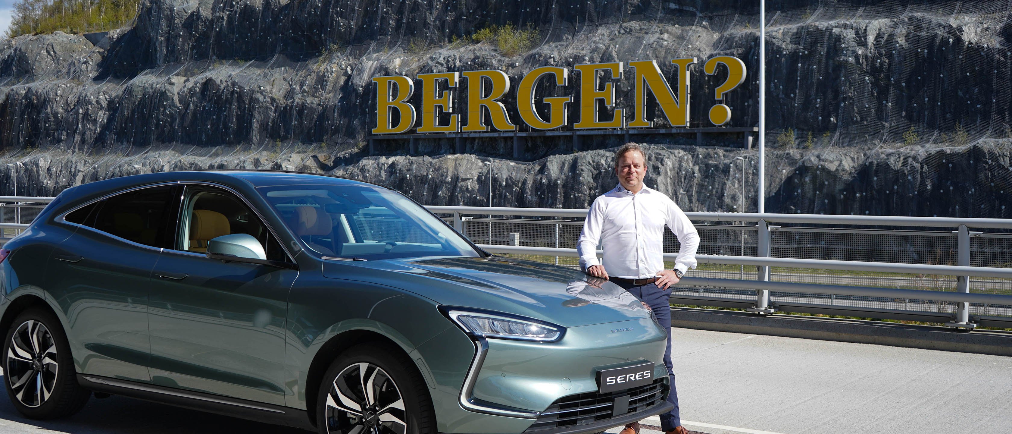 Ansatt i Sandven Auto bak Jaguar-I Pace foran skilt "Bergen?" Selger biler og billån fra Brage Finans.