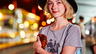 A young adult waits for a tram
