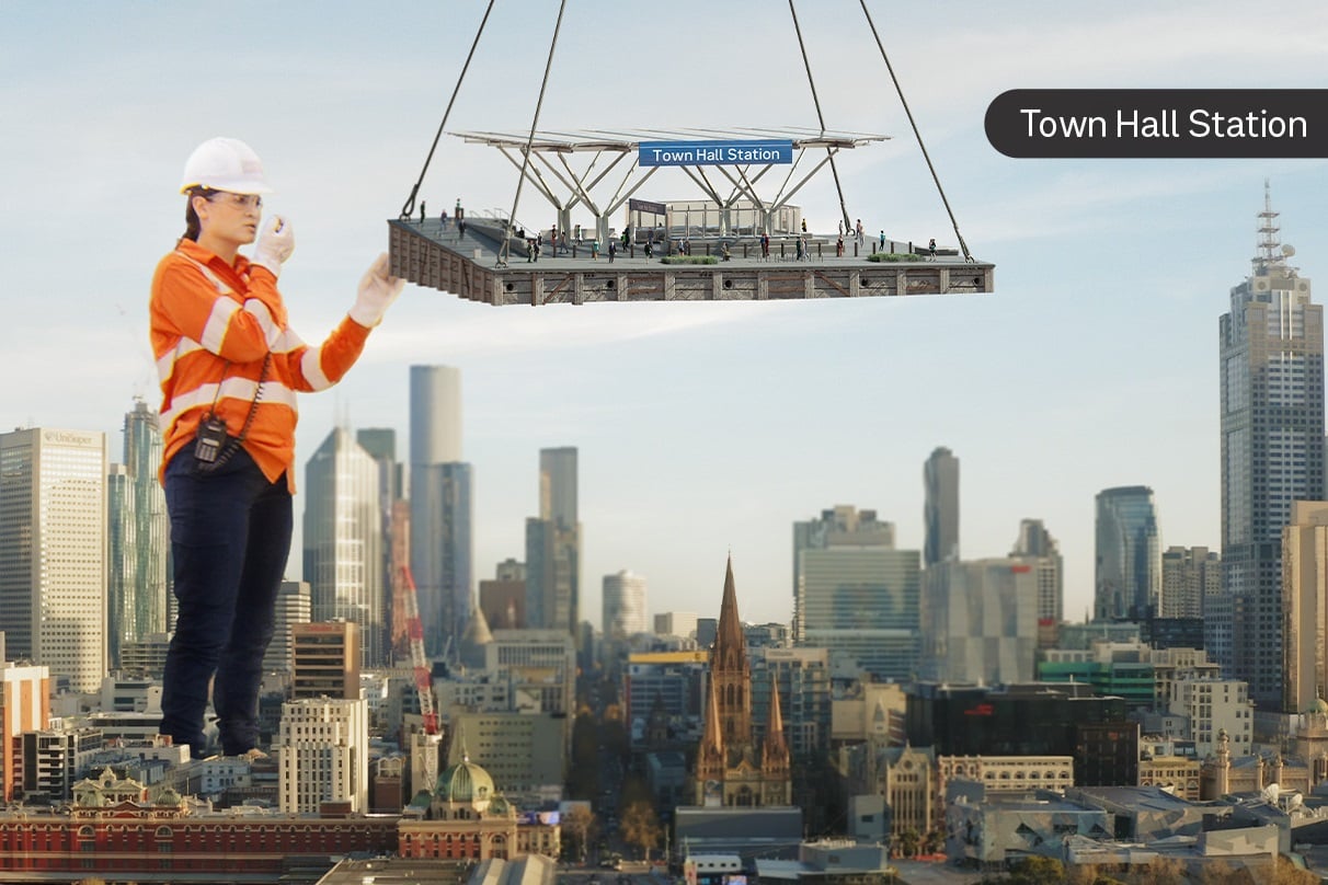 Image of construction worker in a high vis vest guiding a crane