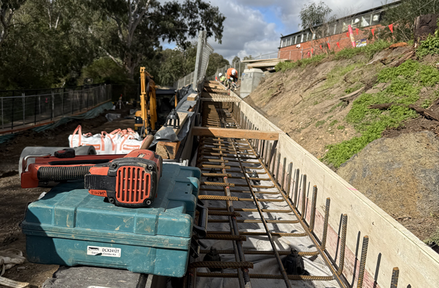 Image of formwork for concrete drain on top of retaining wall at Alphington Link