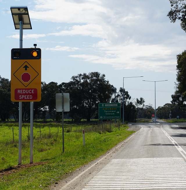 Image of Vehicle activated lights on Labuan Road warn of a major intersection ahead.