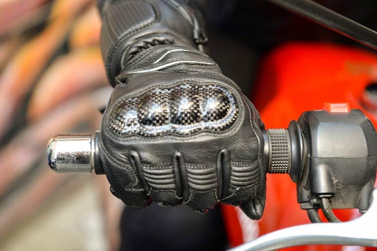 Image of motorcycle glove on a handlebar