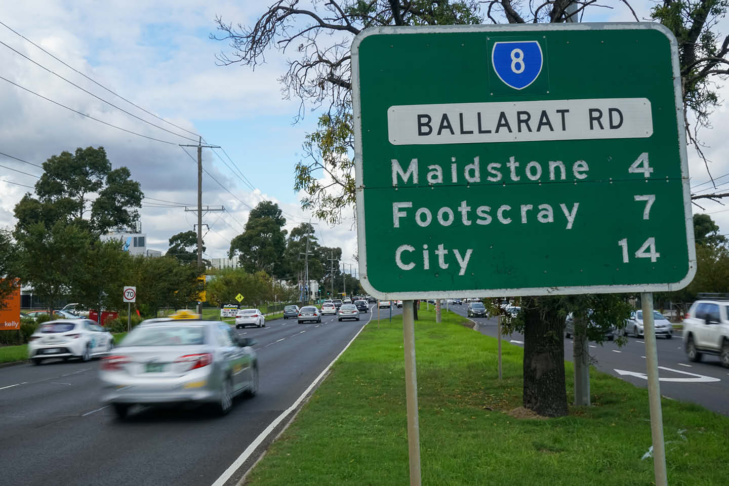 Photograph of an information sign on Ballarat Rd, show the kilometres to Maidstone, Footscray, and the city