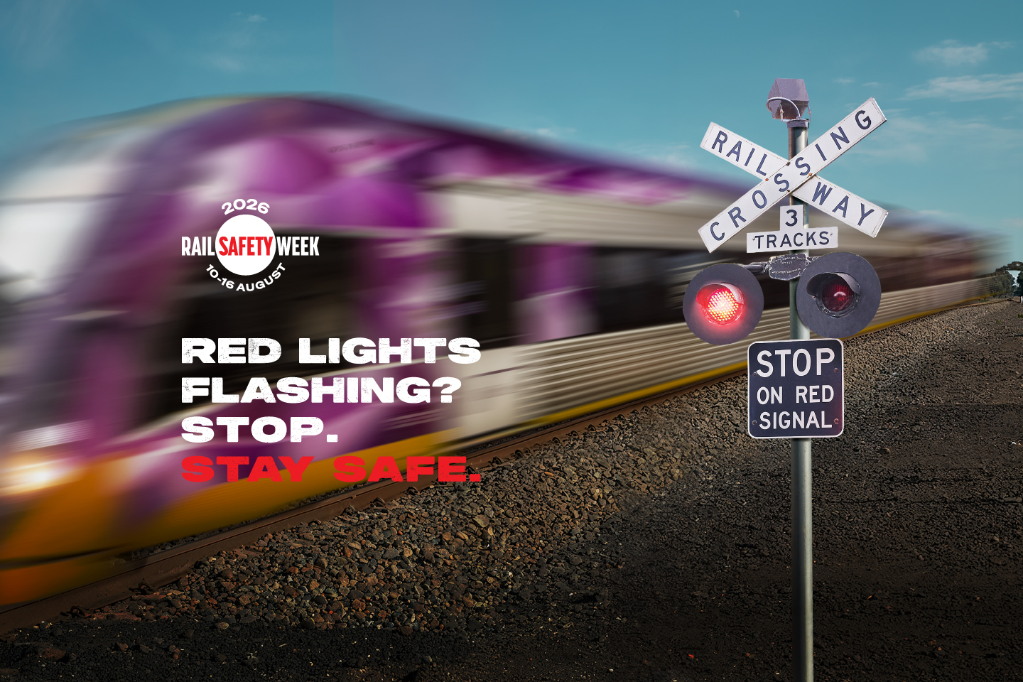 Image of a VLine train passing a level crossing boom gate