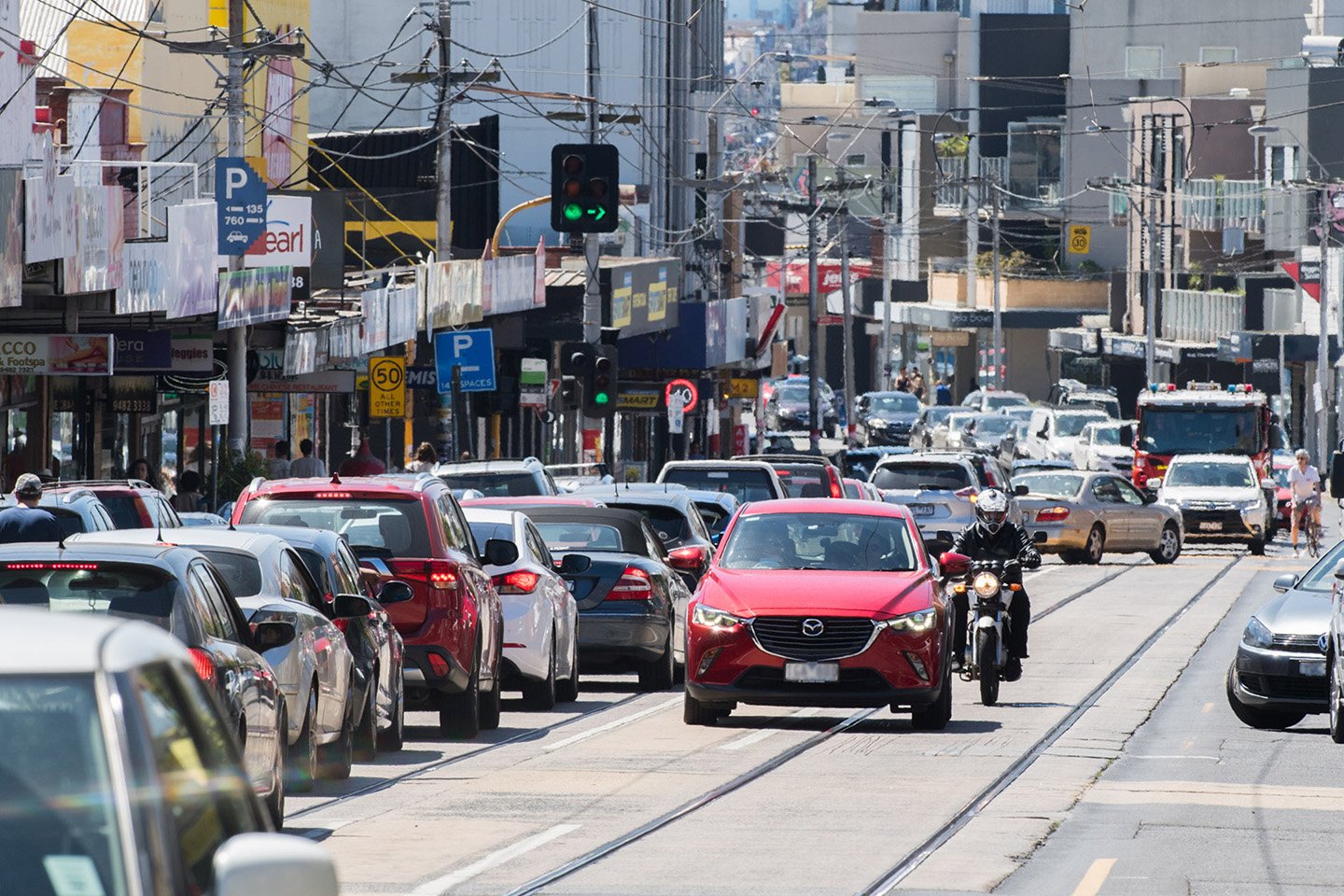 Traffic on a busy road in a suburb