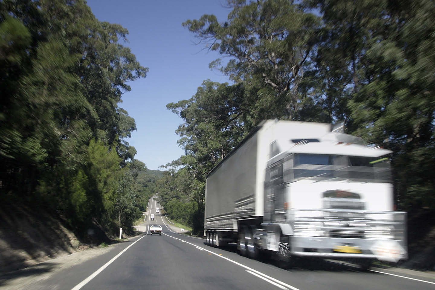 Truck driving on a two-way highway/