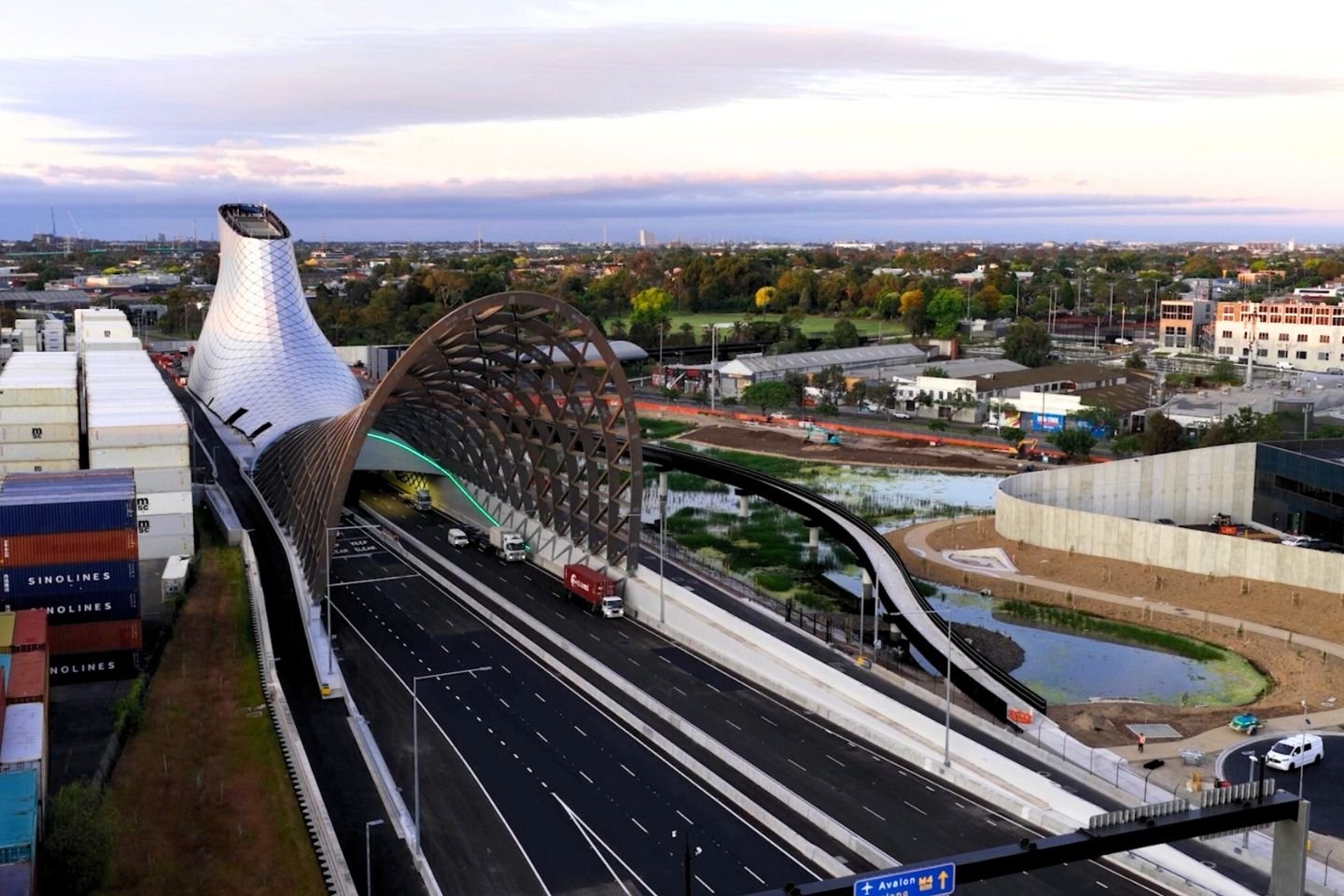 West gate tunnel entrance. You can see shipping containers on the left of the image and a small man-made wetlands on the right.