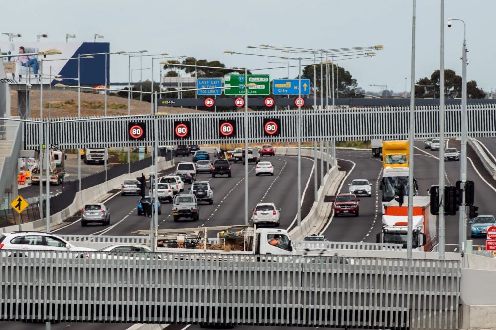 Photograph of traffic on a multi-lane road with electronic speed signs