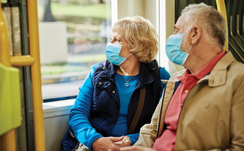 two-seniors-sitting-on-bus