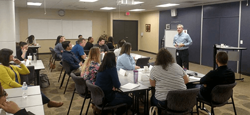 Suncoast employees listen to a presentation on the topic of leadership