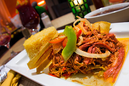 Plate of ropa vieja with rice and plantain chips
