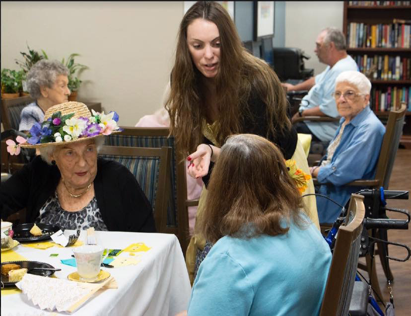 Suncoast Credit Union staff serves treats to residents of Royal Palms Retirement Home