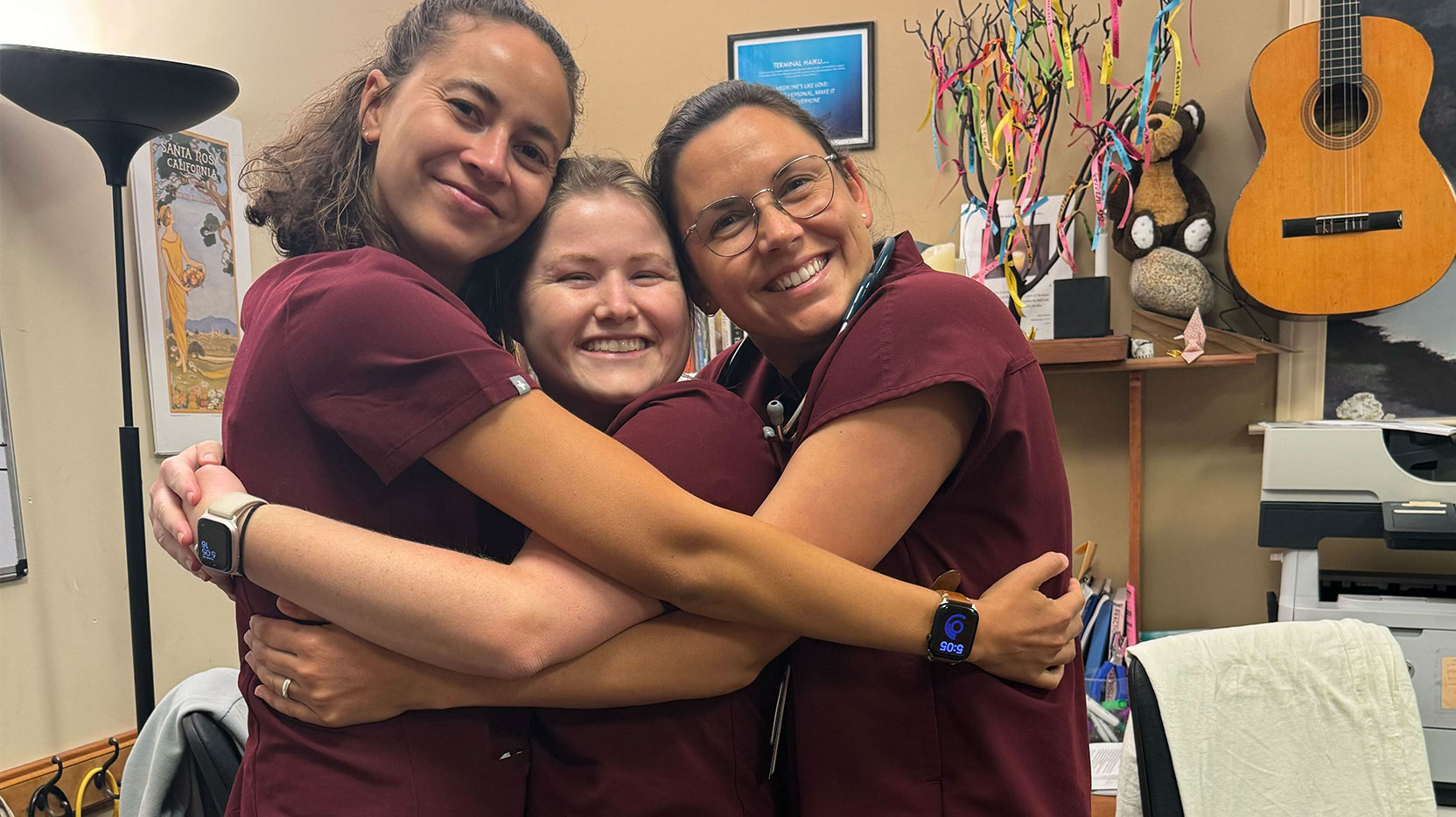 trio-residents-embracing-in-office