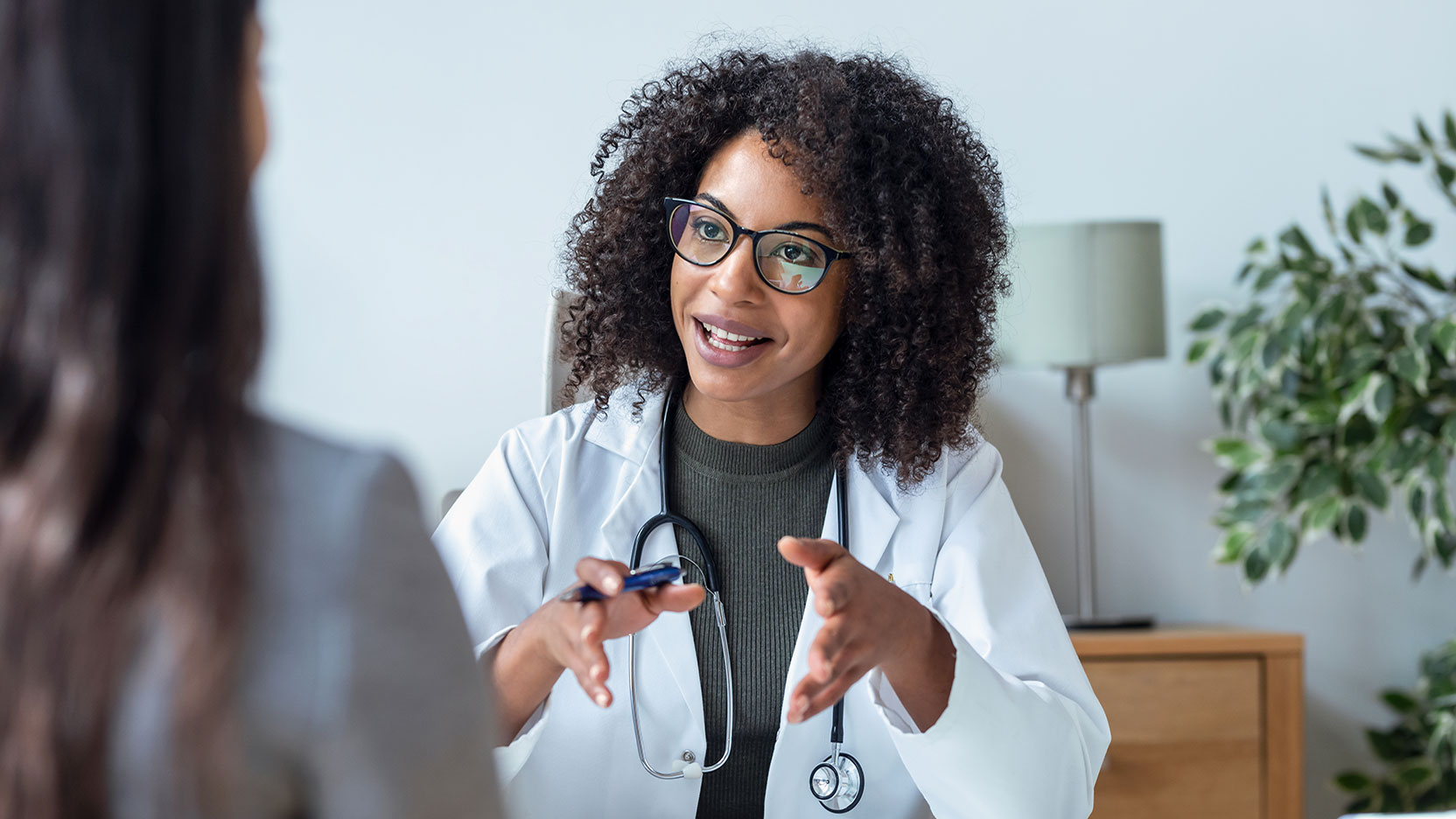 Woman doctor talking with patient