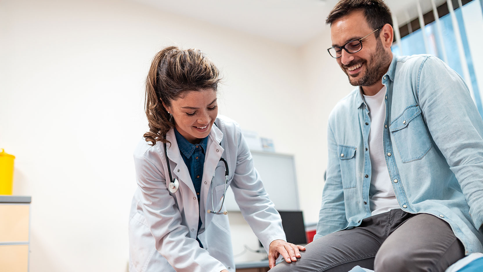 Doctor testing patients knee cap