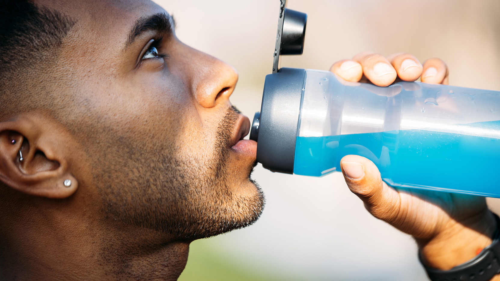 African American male with a bottle of fresh sports hydration drink