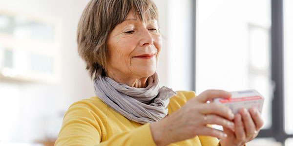 Senior woman reading medicine label