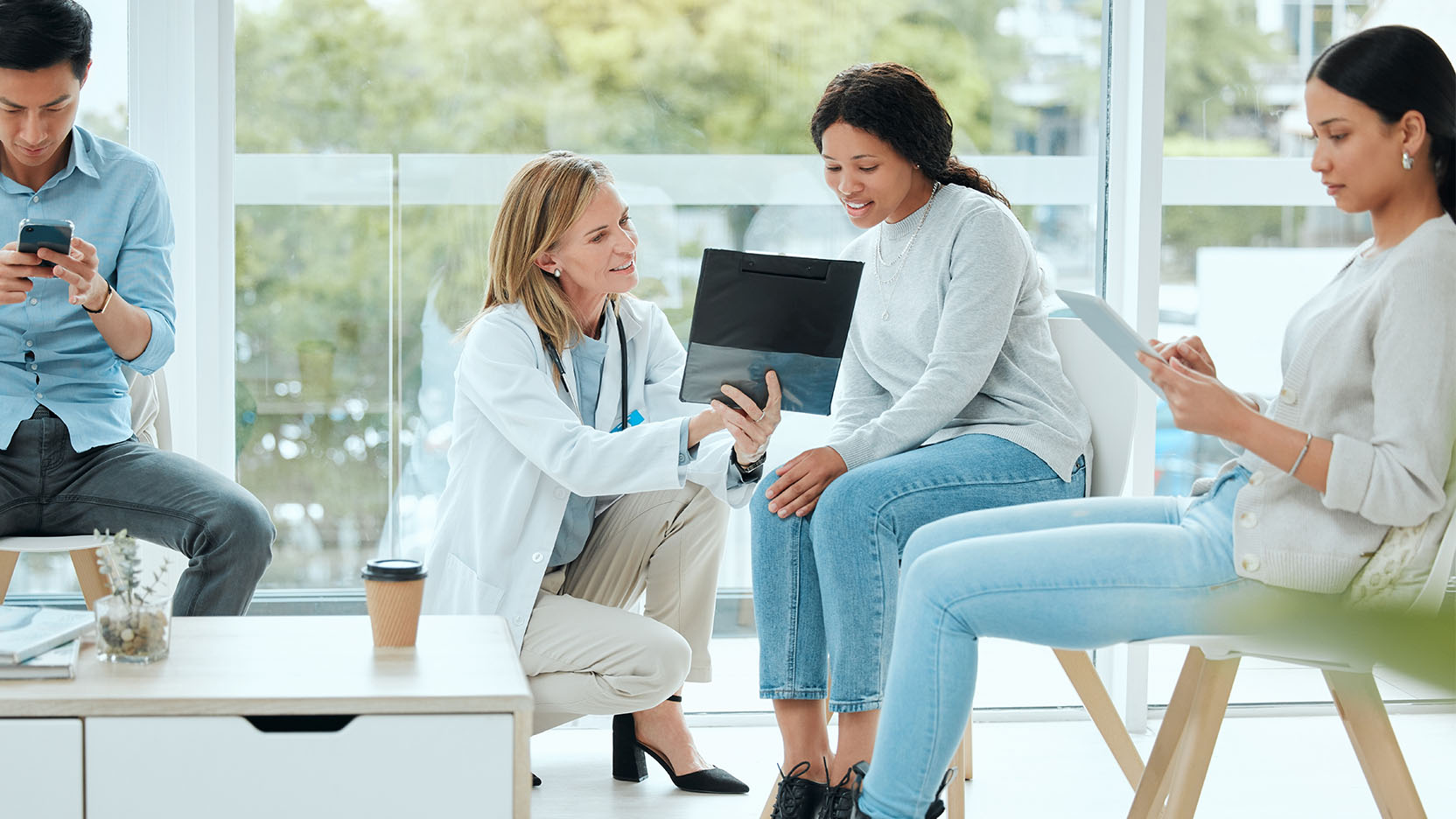 A doctor reviews clinical trial information with a young woman