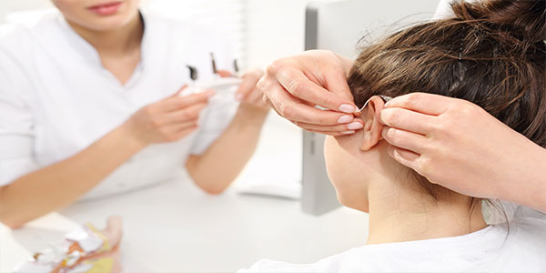 Child Receiving Hearing Aids