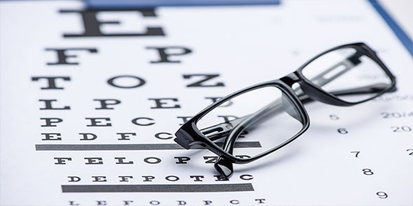 eye glasses and eye chart