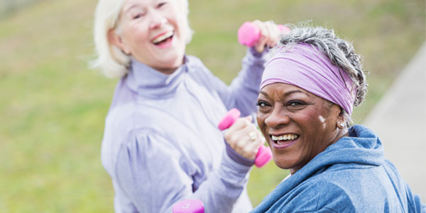 Middle-aged women lifting weights while on walk