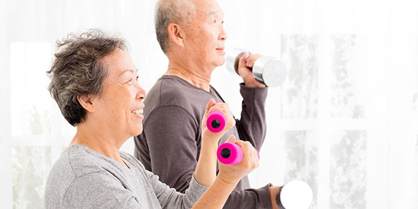 Asian couple lifting weights