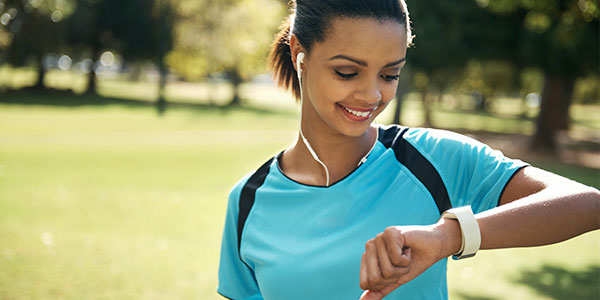 Woman checking fitness device