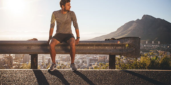man sitting on rail