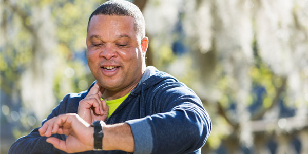 Man taking heart rate outside