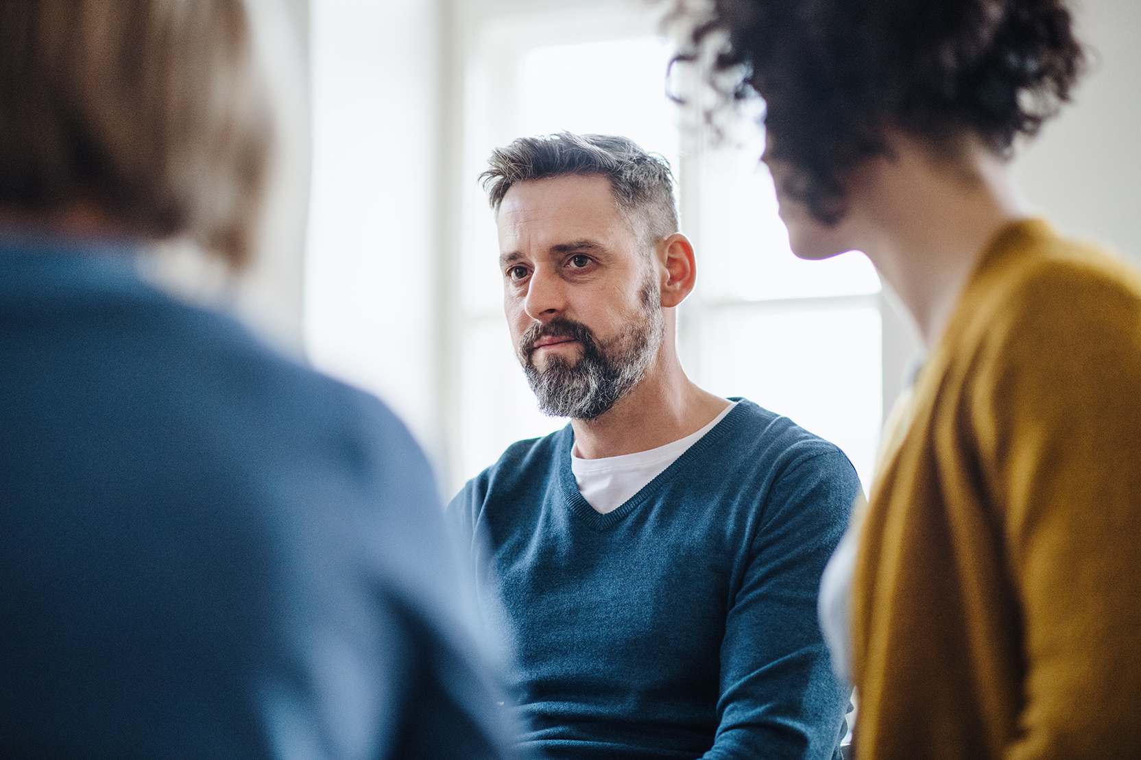 A man listens in group therapy