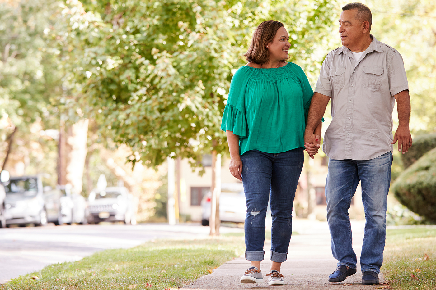 middle aged couple walking and holding hands