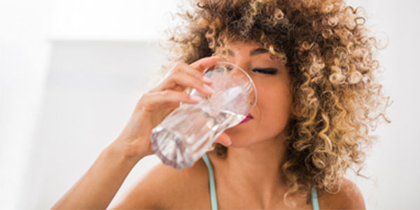 African-American woman drinking water
