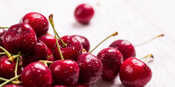 Cherries scattered on a table top
