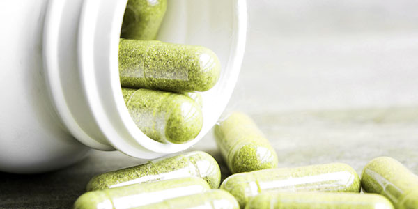 Close up of a bottle of vitamin supplements spilled laying on side