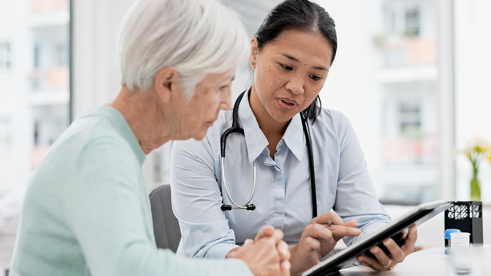 An oncologist goes over a care plan with a patient.