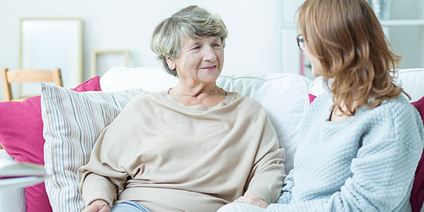 Elderly woman and caregiver
