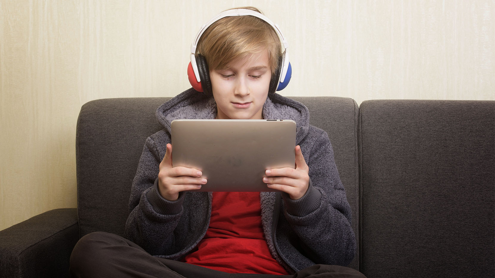Teen boy absorbed in his tablet