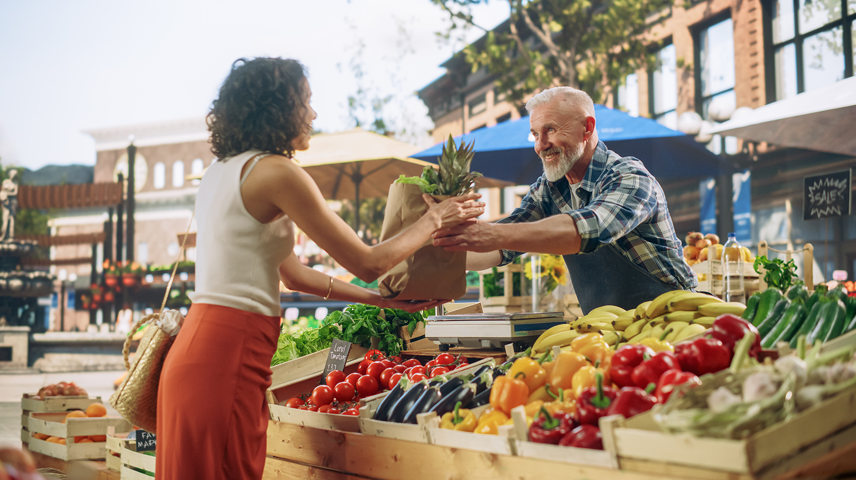 Woman buys fresh produce from vendor at outdoor market