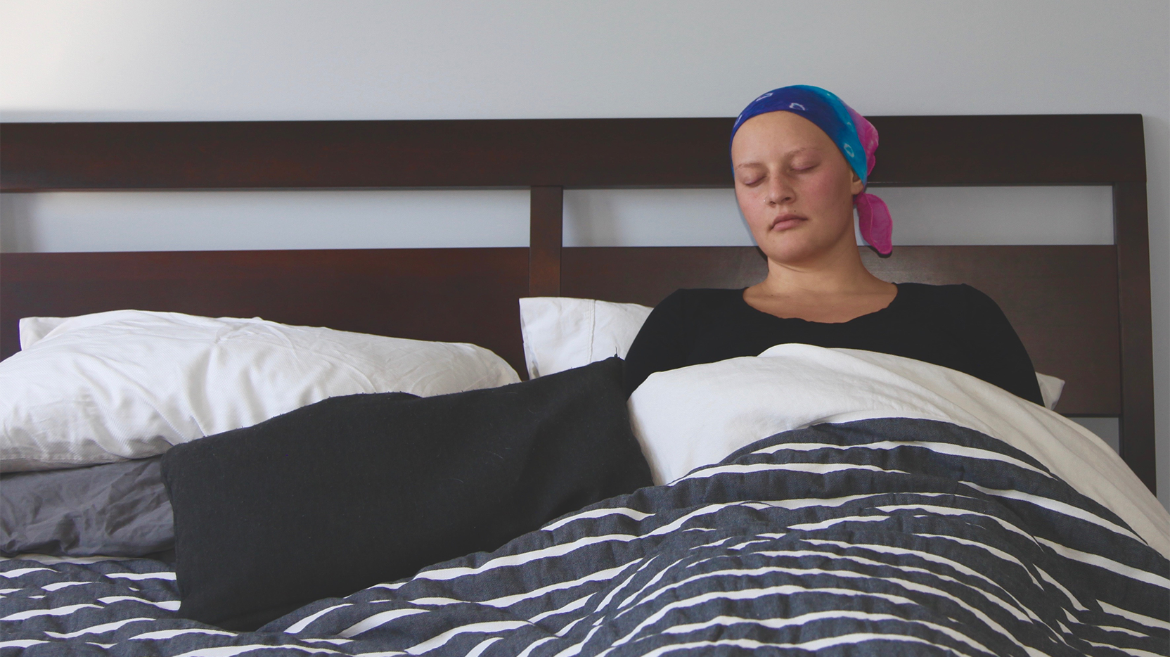 woman with cancer sleeping in bed