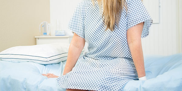 Woman on exam table waiting for checkup