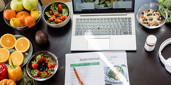 desk with laptop and healthy food