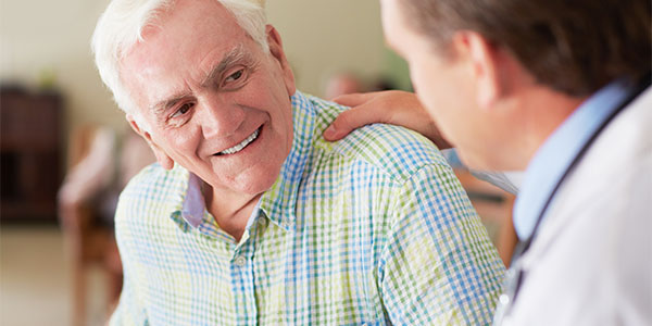 Doctor talking with older man
