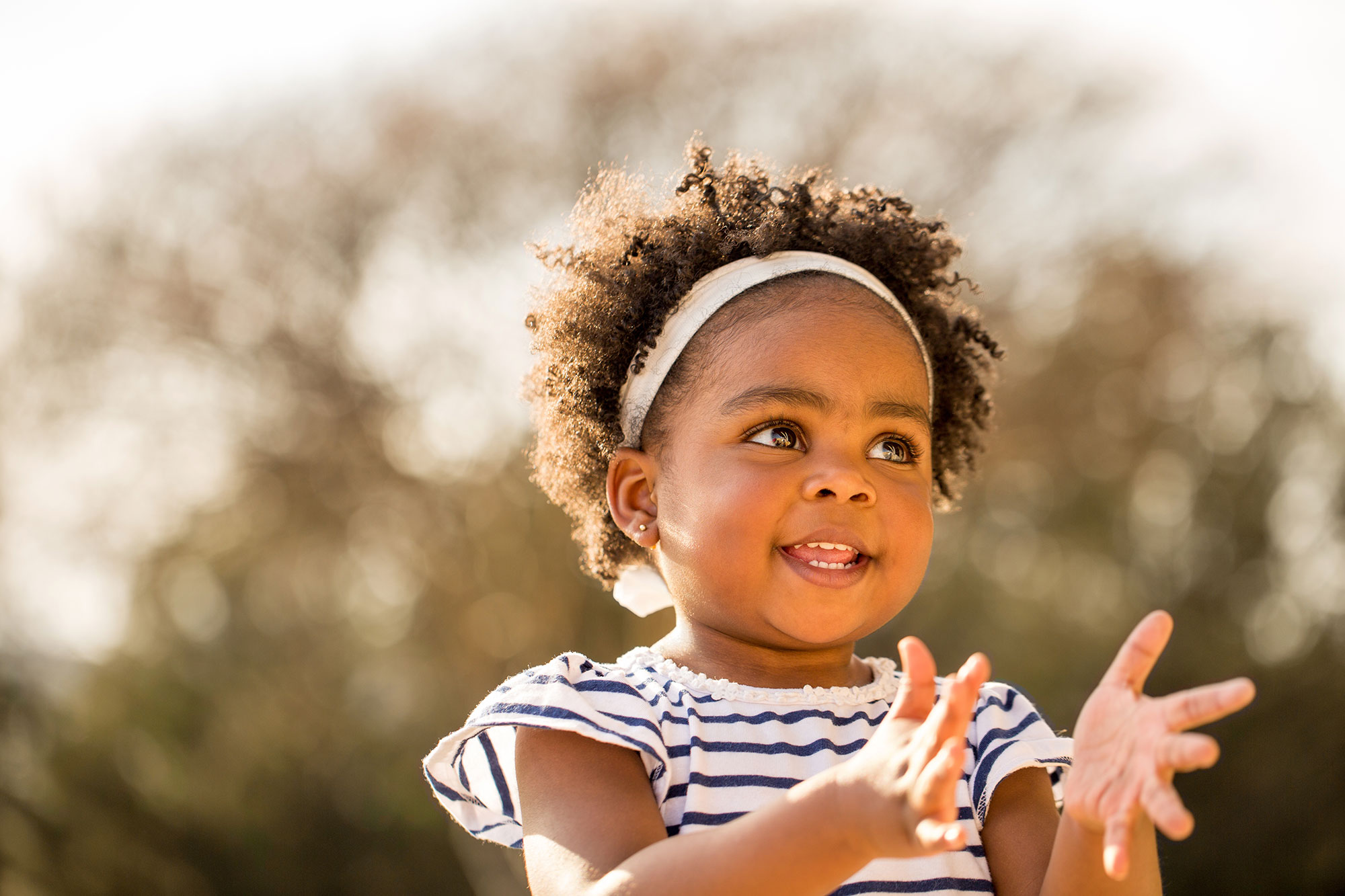 Toddler claps her hands and smiles