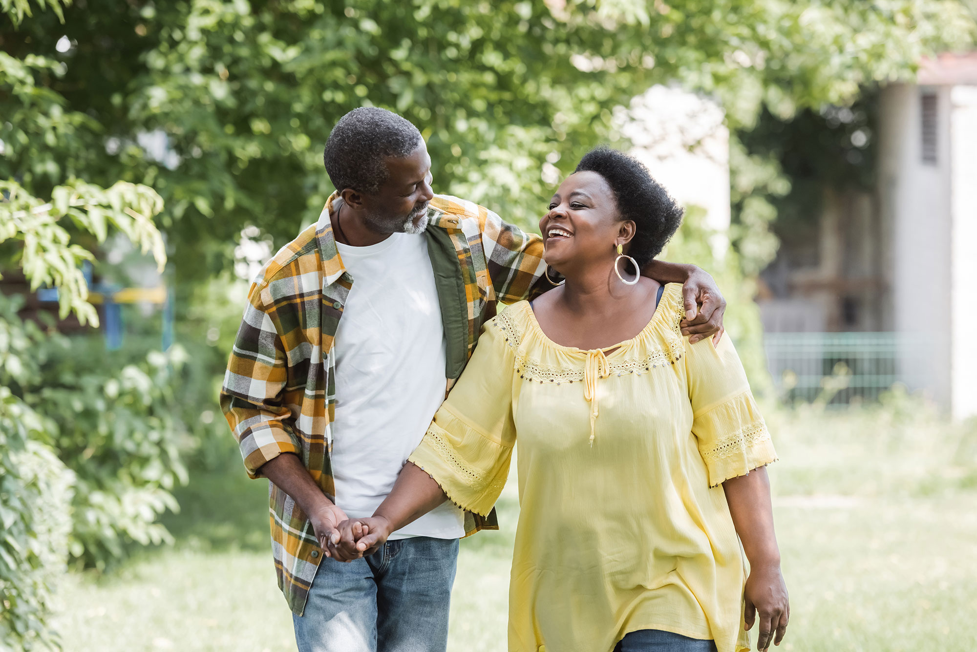 older-couple-walking-smiling-outside