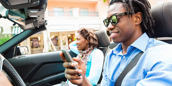 Young man texting while driving