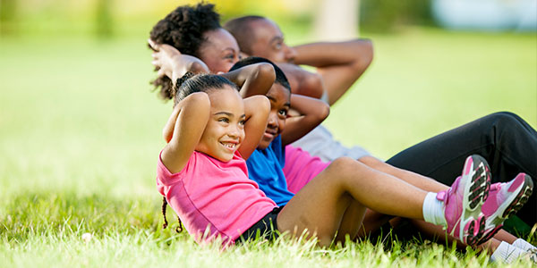 African American family exercising together